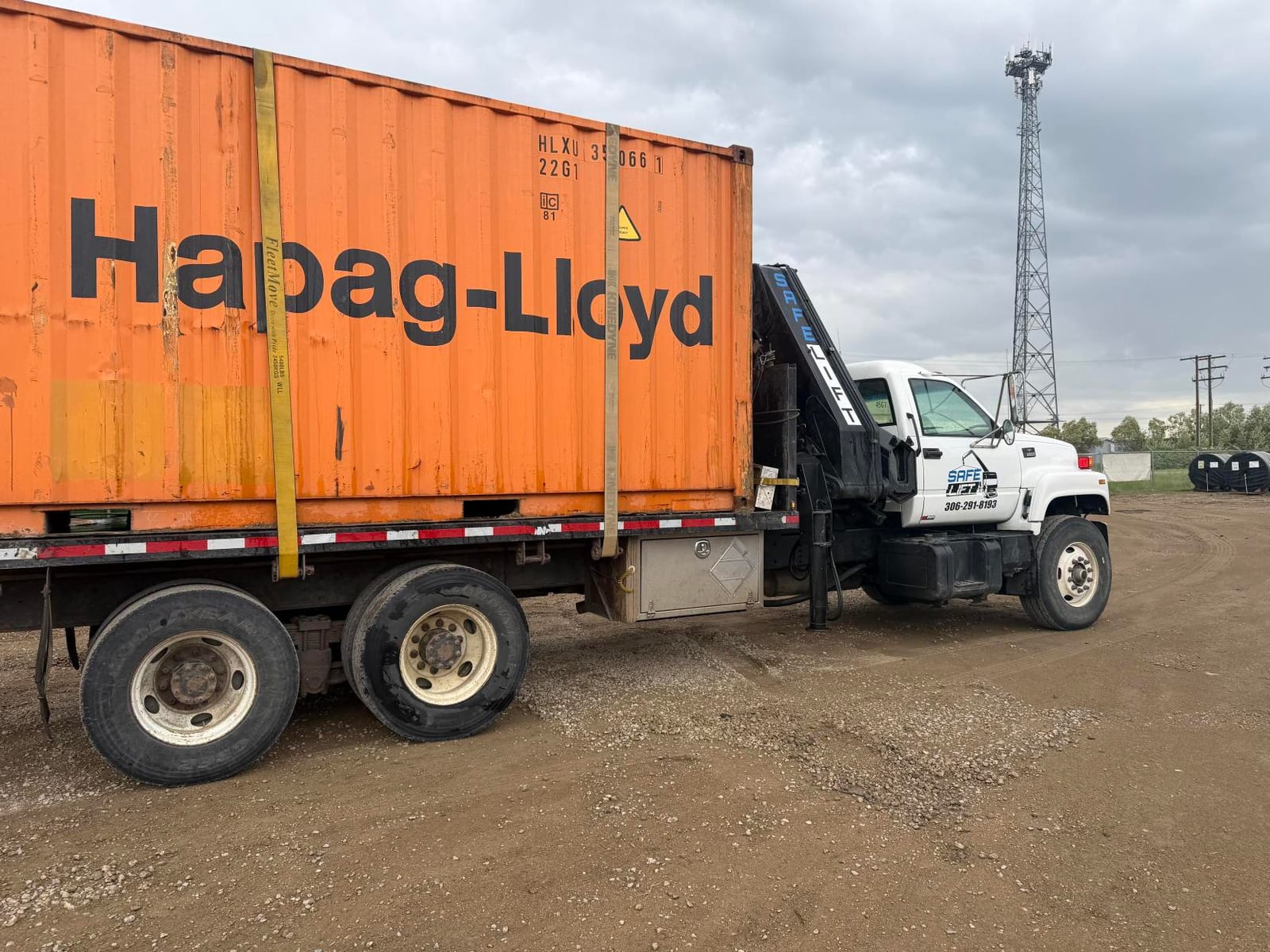 20ft used shipping container loaded on a crane truck for delivery to a northern Saskatchewan community