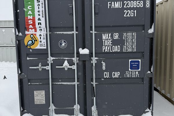20 foot standard shipping container with C-Can Sam branding in Saskatchewan winter